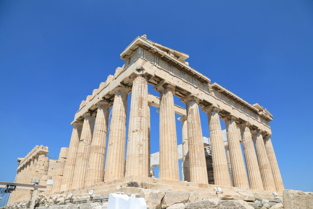 Tempio del Partenone sull’Acropoli di Atene, con colonne doriche in marmo illuminate dal sole e vista panoramica sulla città di Atene in Grecia.